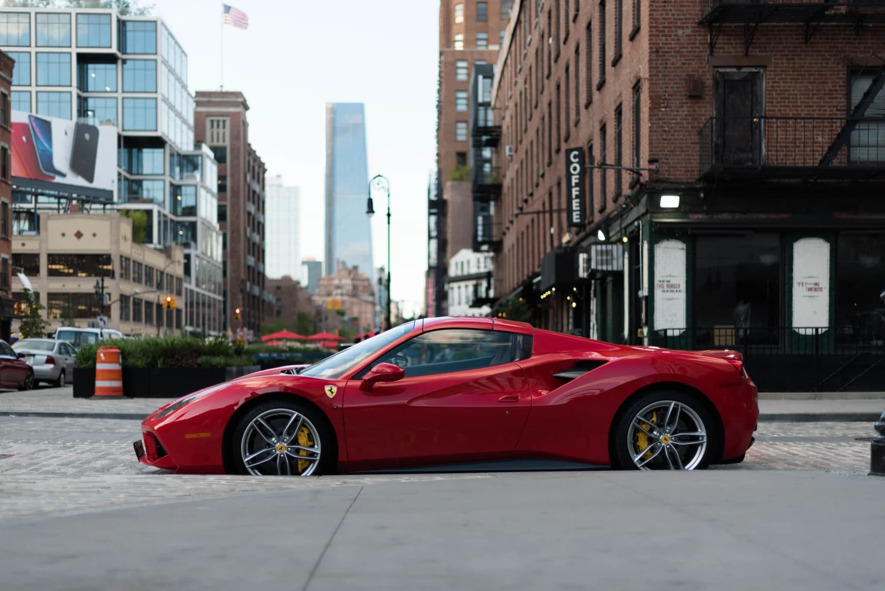 Red Ferrari parked on a city street